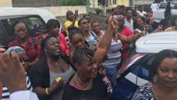 Persons celebrate Farrell's bail outside the Kingstown Magistrate's Court on Monday. (iWN photo)