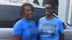 President of the National Council of Women, Beverley Richards, left, and an unidentified woman chat at Heritage Square after the postponement of the march and rally on Friday. (iWN photo)