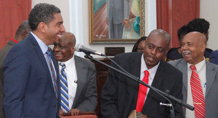 Minister of Finance, Camillo Gonsalves, left, is congratulated by his colleagues after his Budget Address Monday night. (iWN photo)