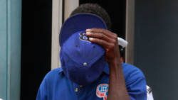 House burglar Daniel Nero uses his hat to hide his face as he is led away to prison on Tuesday. (iWN photo)