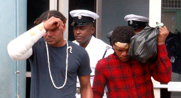 Anthony Hope, 16, of Belair, left, and Jerroy Phillips, 21, of Redemption Sharpes, leave the Kingstown Magistrate's Court after their arraignment on Tuesday. They say they were injured when police beat them during their arrest on Sunday. (iWN photo)