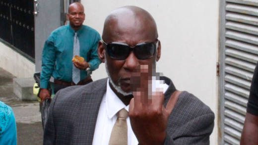 Allie Franklyn-Providence flips reproters off outside of the Serious Offences Court after his conviction on Monday. (iWN photo)