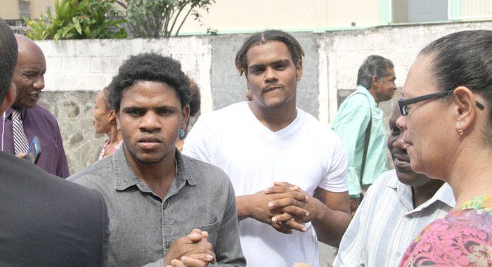 Jerroy Phillips, left, and Anthony Hope outside Kingstown Magistrate's Court on Tuesday. Hope's mother is at right. (iWN photo)
