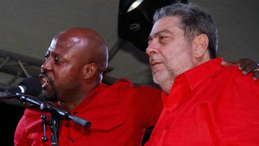 Sen. Carlos James, left, pays homage to Prime Minister Ralph Gonsalves at the ULP's rally in Calliaqua on Sunday. (iWN photo)