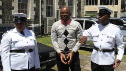 Police officers escort Franklyn from the High Court to the nearby prison after the 144-year sentence was passed down on him. (iWN photo)