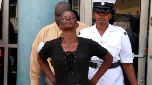 Thotelyn Wilson, 60, poses for photographers as she is led away to prison on Wednesday. (iWN photo)
