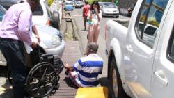 Myers falls from his wheelchair as he made his way from the court to a police vehicle for transportation to prison on Tuesday. Prisons authorities later said they were not equipped to house him (iWN photo)