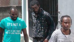 Timron Padmore, left, was freed on Monday of the charges against him. He is seen here with accused Daniel Daniel, left, and Junior Charles, on their way to court. in May 2018 (iWN photo)