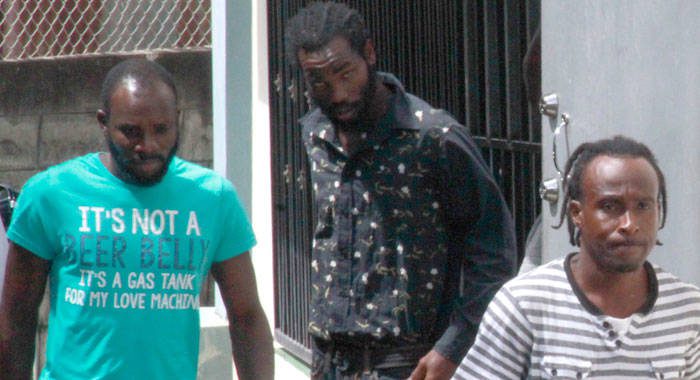 Timron Padmore, left, was freed on Monday of the charges against him. He is seen here with accused Daniel Daniel, left, and Junior Charles, on their way to court. in May 2018 (iWN photo)