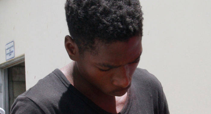 The accused, Clifton Williams, lowers his head in an attempt to avoid being photographed outside the Serious Offences Court on Monday. (iWN photo)