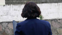Dr. Karen Providence turns her back to the Kingstown Magistrate's Court building and makes the sign of the cross after arriving on Tuesday. (iWN photo)