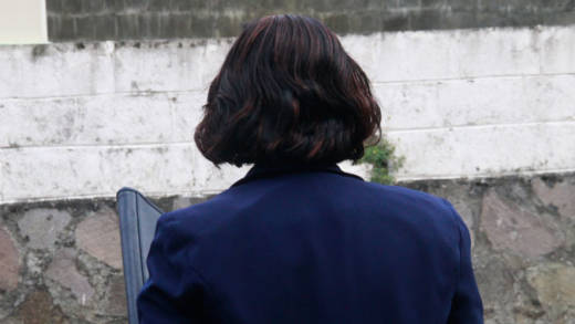 Dr. Karen Providence turns her back to the Kingstown Magistrate's Court building and makes the sign of the cross after arriving on Tuesday. (iWN photo)