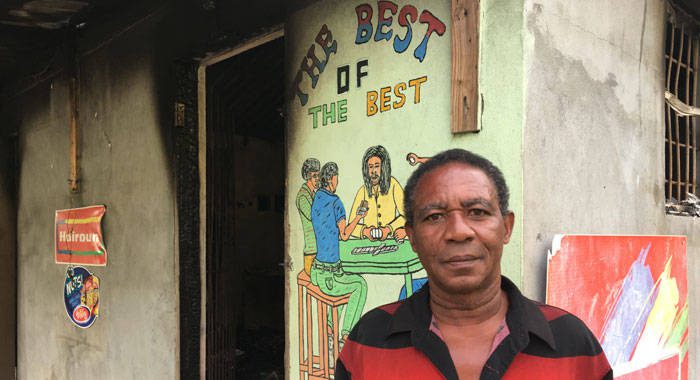 Businessman Rawle Francis stand outside his burnt-out shop in Pierre Hughes, Barrouallie, on June 26, 2018, three days after it was burglarised then set on fire. (iWN photo)
