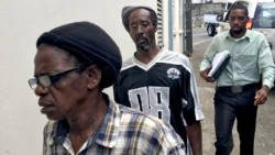 Detective Corporal Philbert Chambers, left, escorts Gailene Farrell, right, and her common-law husband, Calvert Charles to the Serious Offences Court in Kingstown on Friday. (iWN photo)
