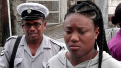 Timika Mc Lean is escorted to the Kingstown Magistrate's Court on Monday. (iWN photo)