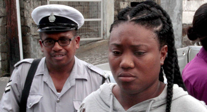 Timika Mc Lean is escorted to the Kingstown Magistrate's Court on Monday. (iWN photo)