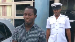 Accused murderer Anwar Jack is escorted from the Kingstown Magistrate's Court on Wednesday. (iWN photo)