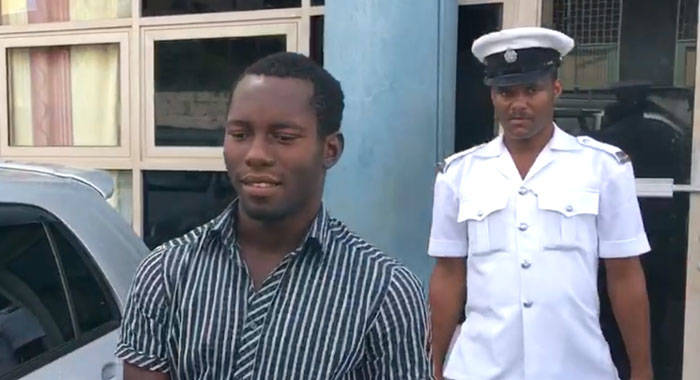 Accused murderer Anwar Jack is escorted from the Kingstown Magistrate's Court on Wednesday. (iWN photo)