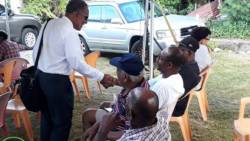 Opposition Leader Godwin Friday greets persons at the NDP's Arrowroot Forum in Owia on Sunday. (NDP photo)