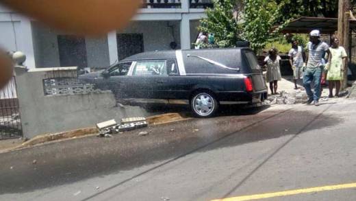 The hearse crashed into this property in Layou.