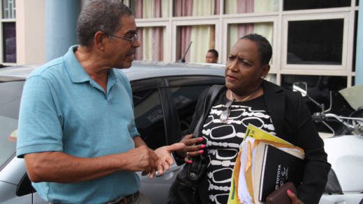 The accused, Douglas De Freitas, left, and his lawyer, Kay Bacchus-Baptiste speak outside the court after her court appearance last Tuesday. 