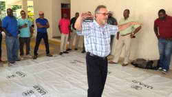 USAID/OFDA's Senior Shelter & Settlements and Hazard Mitigation Advisor Chuck Setchell captures the attention of participants during the Plastic Sheeting Training workshop.