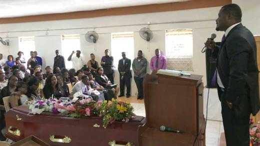 Rev. Kelron Harry preaches the sermon at Brenda Layne funeral in Rllan Hill on Sunday. (iWN photo)