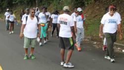 Opposition Leader Godwin Friday, left, leads the walk against crime and for jobs on Saturday. (iWN photo)