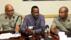 Police IT specialist, Corporal Syon Shoy, centre, explains the features of the new police ID. Also in photo are acting Commissioner of Police, Colin John, right, and Assistant Commissioner of Police, Richard Browne. (iWN photo)