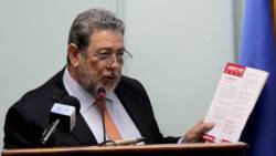 Prime Minister Ralph Gonsalves holds up a copy of his party's 2015 manifesto at Monday's consultation with SVG diplomats. (iWN photo)
