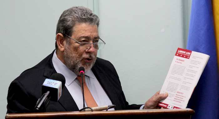 Prime Minister Ralph Gonsalves holds up a copy of his party's 2015 manifesto at Monday's consultation with SVG diplomats. (iWN photo)