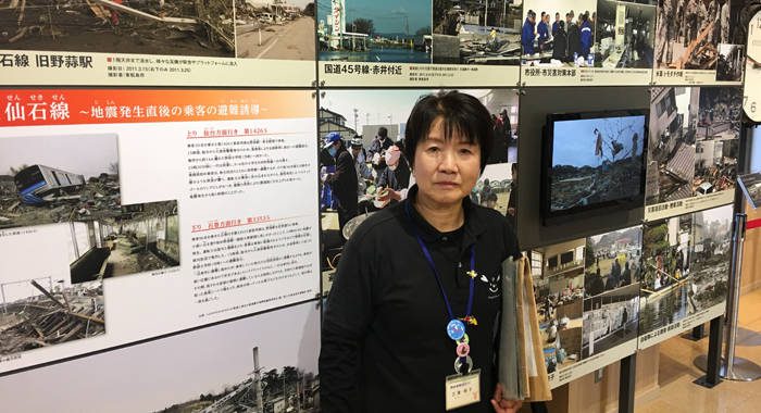 Tour guide Toshiko Miura stands inside a museum and information centre in Nobiru, Higashimatsushima, Japan. The centre documents the 2011 earthquake and tsunami, which claimed the lives of thousands, including her father. (iWN photo)