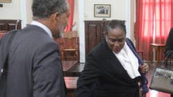 Lawyer for the petitioners, Kay Bacchus-Baptiste, right, and Opposition Leader Godwin Friday prepare to leave the High Court on Friday, after the hearing. (iWN photo)