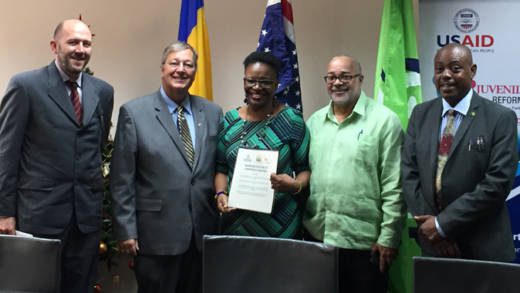 From left: USAID General Development Office Director Kipp Sutton, USAID Mission Director Christopher Cushing, Permanent Secretary in the Ministry of Social Mobilisation, Nerissa Gittens-McMillan, Director General of the OECS Commission Didacus Jules and Minister for Social Mobilization Frederick Stephenson pose with the signed MOU following the ceremony.