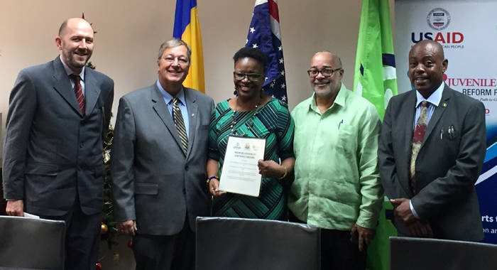 From left: USAID General Development Office Director Kipp Sutton, USAID Mission Director Christopher Cushing, Permanent Secretary in the Ministry of Social Mobilisation, Nerissa Gittens-McMillan, Director General of the OECS Commission Didacus Jules and Minister for Social Mobilization Frederick Stephenson pose with the signed MOU following the ceremony.