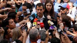 Venezuelan opposition leader and self-proclaimed interim president Juan Guaido, accompanied by his wife Fabiana Rosales, speaks to the media after mass at a local church in Caracas on Sunday. (Carlos Barria/Reuters)