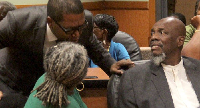 Central Leeward petitioner Benjamin "Ben" Exeter, centre, chats with former Leader of the Opposition, Arnhim Eustace, right, under whose leadership the NDP filed the petitions, chats with and Mrs. Jennifer Eustace. during the hearing. (iWN photo)