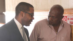 The petitioners, Ben Exeter, left, and Lauron "Sharer" Baptiste in conversation during the trial in March. (iWN photo)
