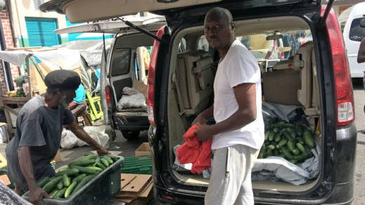 A man sells cucumbers in Kingstown on March 15, 2019. The CDB said that in 2019, economic activity in SVG is expected to benefit from initiatives to improve competitiveness in agriculture and, among other things, tourism. (iWN photo)
