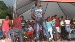 Soca artiste Delroy “Fireman” Hooper and children on stage during the National Heroes Day celebrations in Fancy last year. (iWN photo) 
