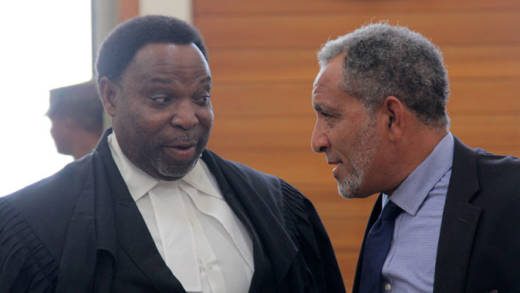Keith Scotland, senior counsel in the North Windward petition, left, chats with Opposition Leader Godwin Friday outside the courtroom last Wednesday. (iWN photo)