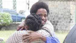 Kishroy “Orchard” John get a tight embrace from this woman when he walked out of the High Court on Friday, having received a suspended sentence for manslaughter.