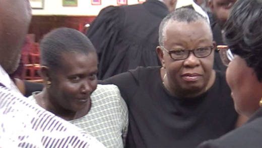 Presiding officer for NWI Veronica John, left, and former Supervisor of Election, Sylvia Findlay-Scrubb and other persons in a huddle inside the courtroom after the judgement on Thursday. (iWN Photo)  