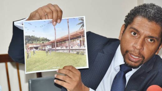 Minister of Finance, Camillo Gonsalves holds up an artist impress of one of the hotels that his government plans to build. (Photo: Lance Neverson/Facebook)