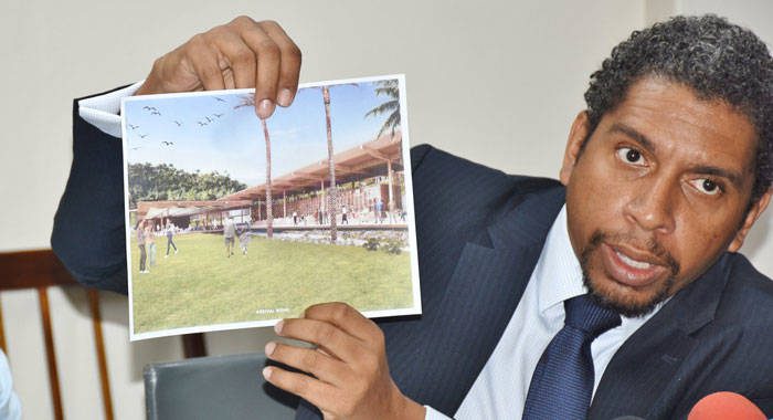 Minister of Finance, Camillo Gonsalves holds up an artist impress of one of the hotels that his government plans to build. (Photo: Lance Neverson/Facebook)