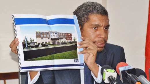 Minister of Finance, Camillo Gonsalves hold up a concept design of the hotel.  (Photo: Lance Neverson/Facebook)