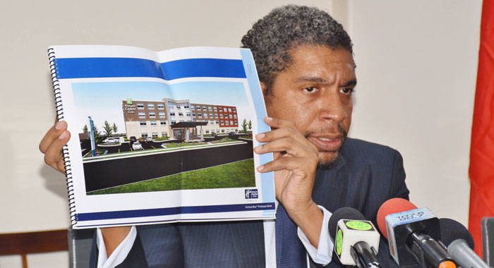 Minister of Finance, Camillo Gonsalves hold up a concept design of the hotel.  (Photo: Lance Neverson/Facebook)