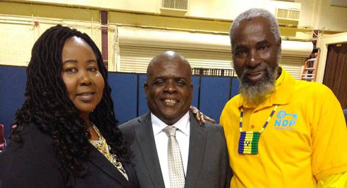 St. Vincent and the Grenadines lawmaker, Roland "Patel" Matthews, centre, pose with persons at Saturday's town hall meeting in New York. 
