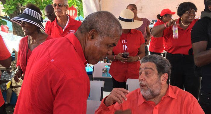 Prime Minister Ralph Gonsalves, right, chats with Minister of Housing, Montgomery Daniel at Thursday's rally in Kingstown. (iWN photo)