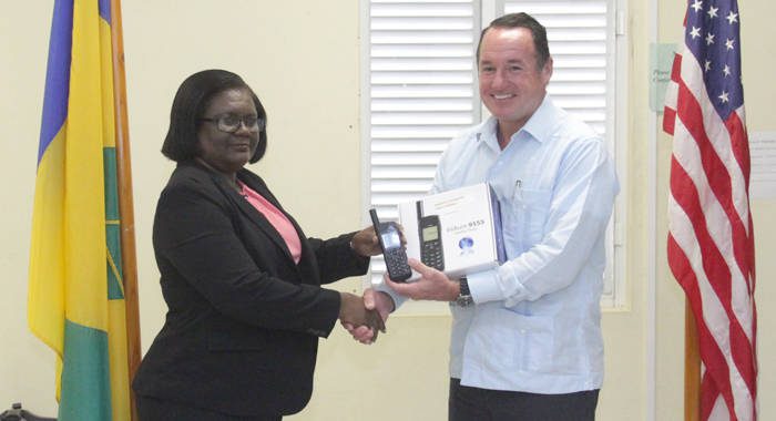 Director of NEMO, Michelle Forbes, right, receives the phones from Joaquin F. Monserrate, deputy chief of mission at the US Embassy in Barbados, in Kingstown on Thursday. (iWN photo) 